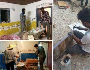 Workers rebuilding damaged homes, reflecting the impact of crypto zakat and aid distribution efforts in war-torn regions. The image shows men working with tools, wheelbarrows, and building materials, symbolizing reconstruction and support for the Muslim Ummah. This portrays how donations, potentially including ETH, contribute to relief and rebuilding.
