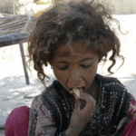 Child eating, implying aid is processed via USDT for humanitarian relief.
