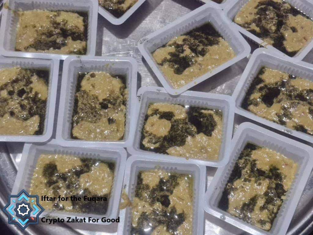 Individual portions of Iftar meals in white containers, ready for distribution. This image supports the page topic of Giving Iftar in Ramadan 2026: Donate with Cryptocurrency, highlighting the importance of Iftar donations for the needy, with crypto support, and features the selected coin, USDT.