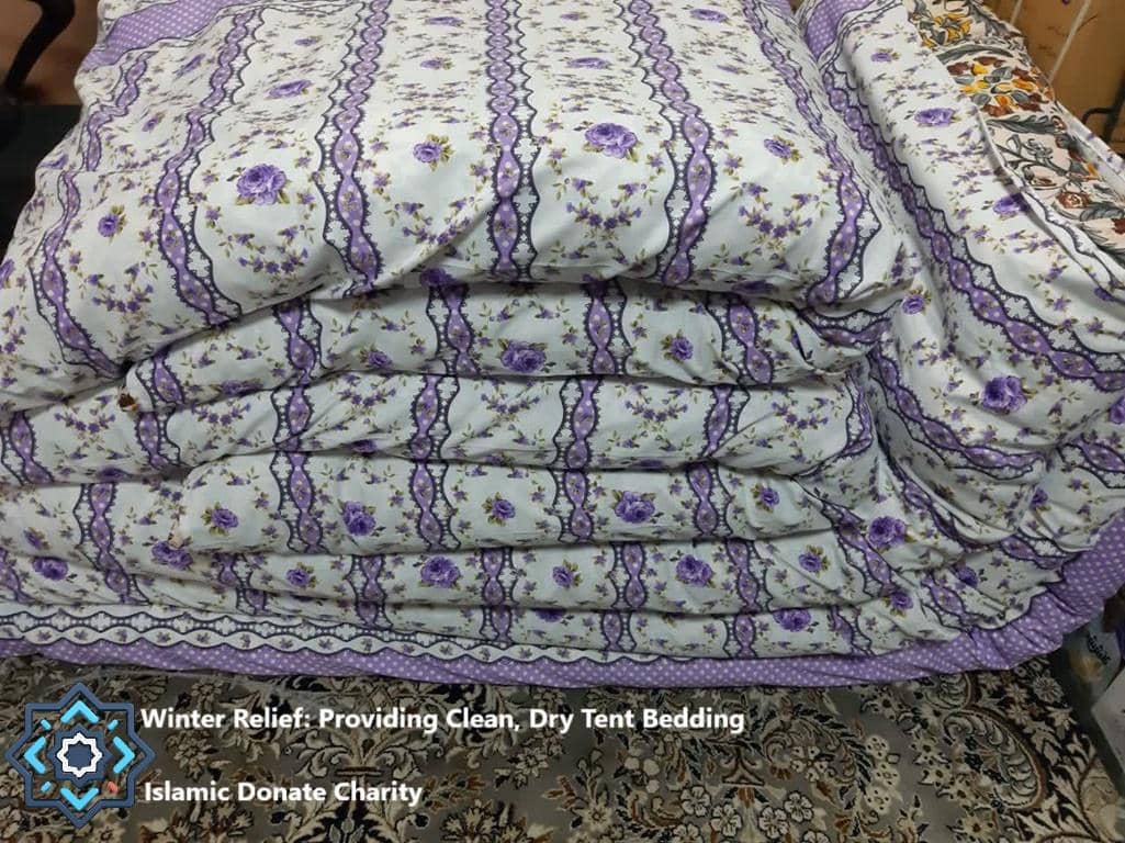 Stacked clean, floral patterned blankets for winter relief, made possible by crypto donations like BTC.