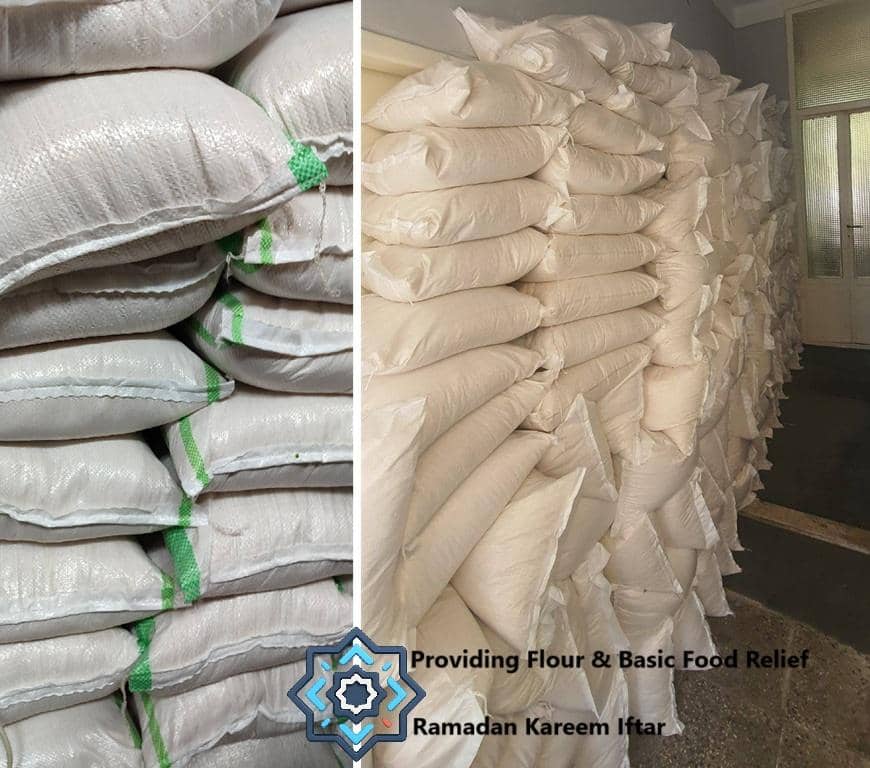 Sacks of flour stacked high, symbolizing food relief for Ramadan Iftar, supported by crypto donations like ETH.