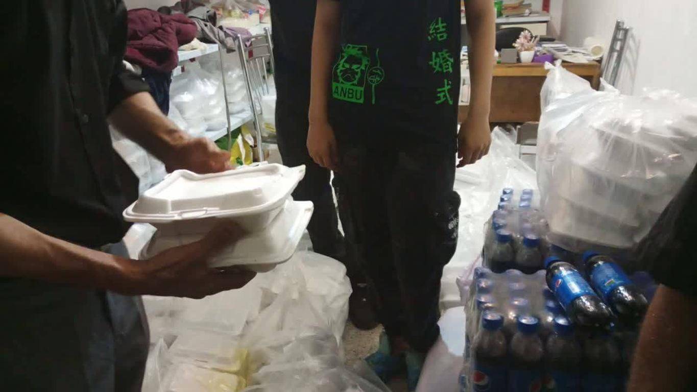 Hands stacking containers for food distribution, implying crypto-funded aid via ETH., Muslims helping Muslims, Ramadan donations, food for needy, charity.