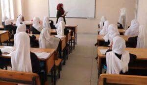 A teacher in a hijab leads a classroom of female students, many wearing hijabs, in a lesson. Donation via ETH.