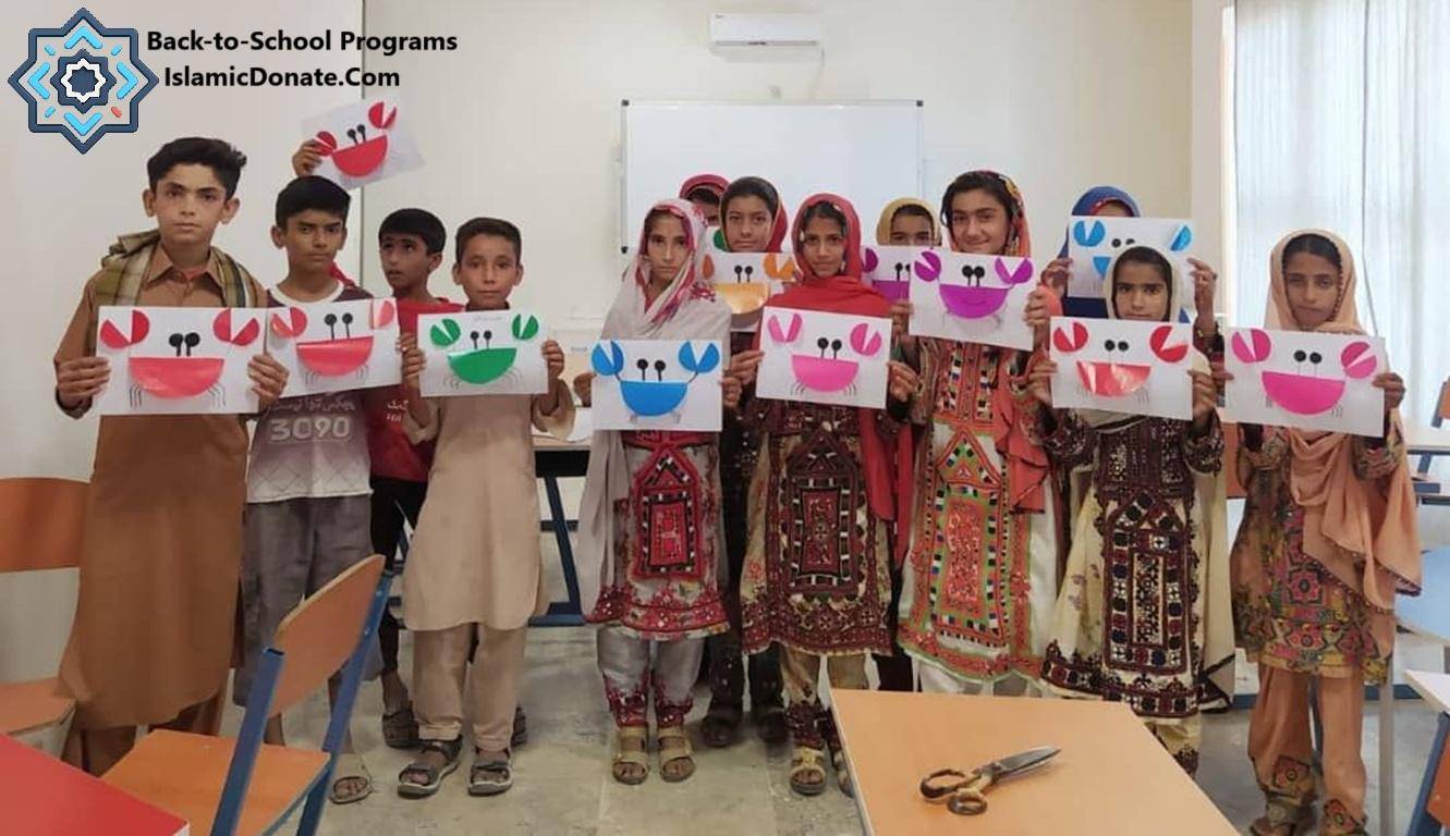 Children proudly display their colorful crab crafts at a Back-to-School Program by IslamicDonate.com, symbolizing educational empowerment facilitated by crypto donations like BTC.