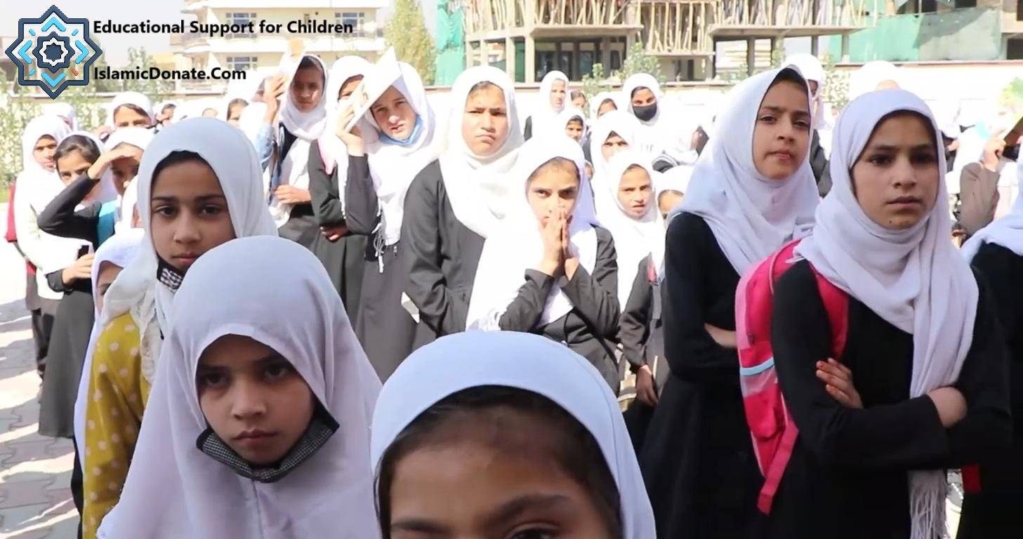 Children in Muslim attire lining up, some with headscarves, representing educational support for youth in Asia and Africa funded by crypto donations like BTC.
