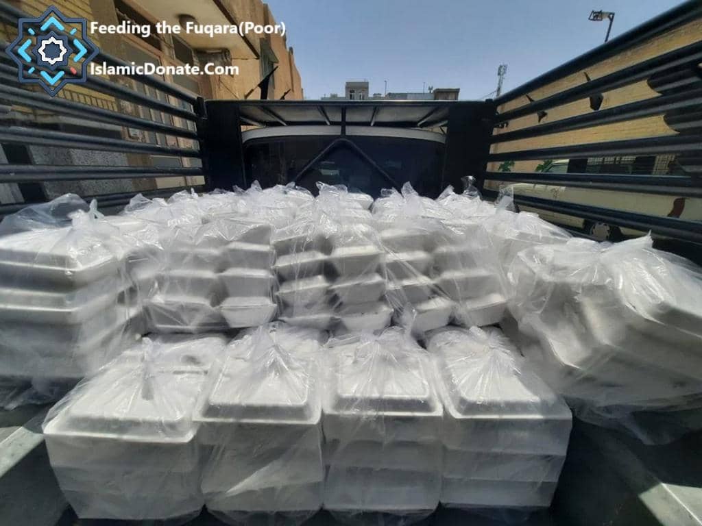 Kaffarah donation of stacked meal containers ready for distribution, some loaded in a truck, indicating sustenance for the needy and supported by crypto via USDT.