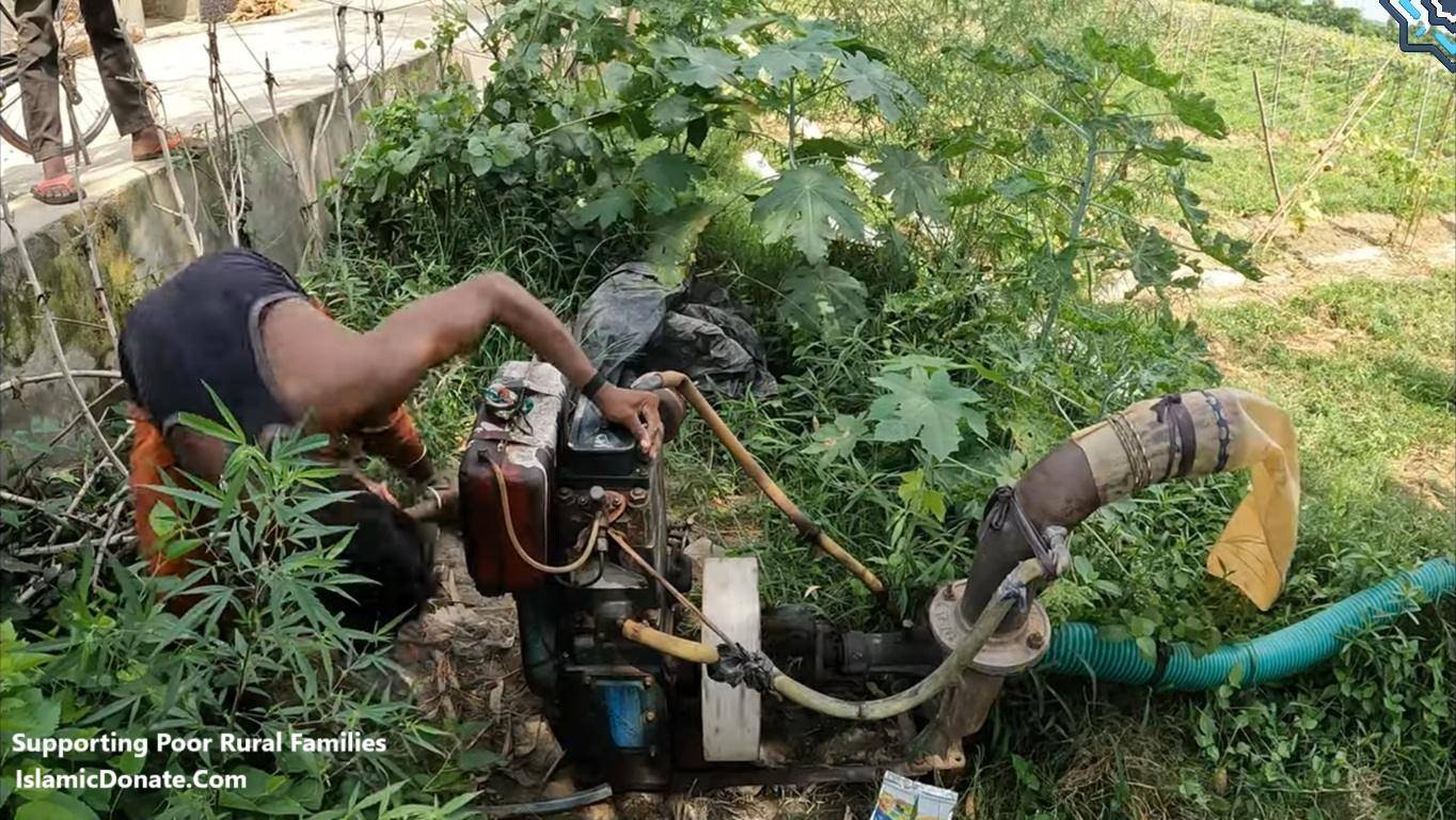 Man tending to a water pump and hose, symbolizing investment in sustainable farming and livelihood support for poor rural families, with donations processed via USDS.