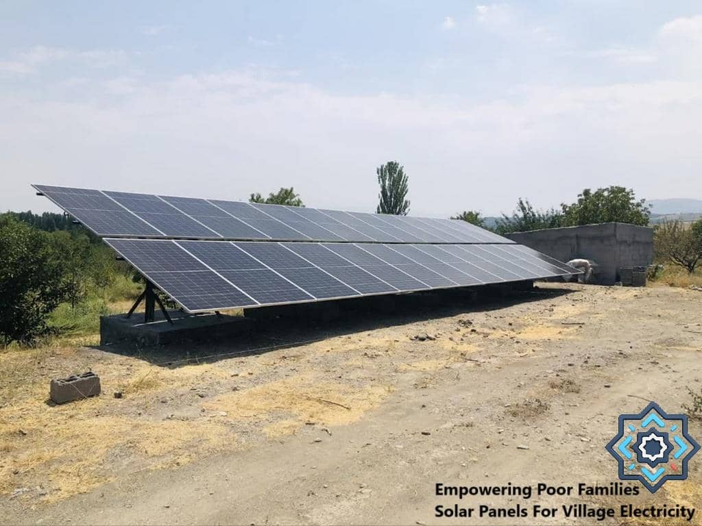 Solar panels installed in a rural area, providing solar energy for village electricity, supported by crypto donations like ETH. Empowering poor families is key.