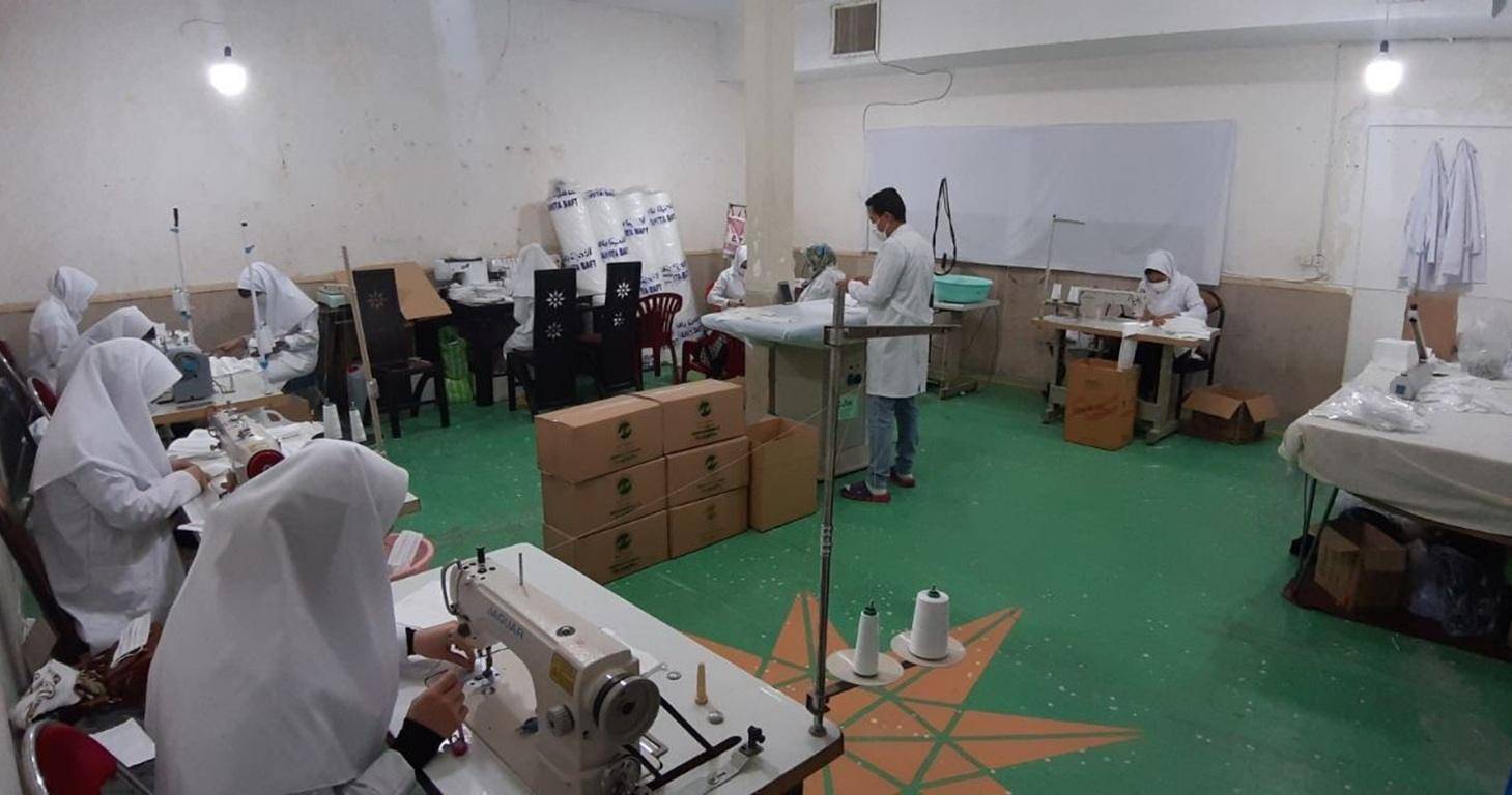 Women in a sewing workshop learn tailoring skills, creating income and dignity through crypto donations. Funded by ETH.