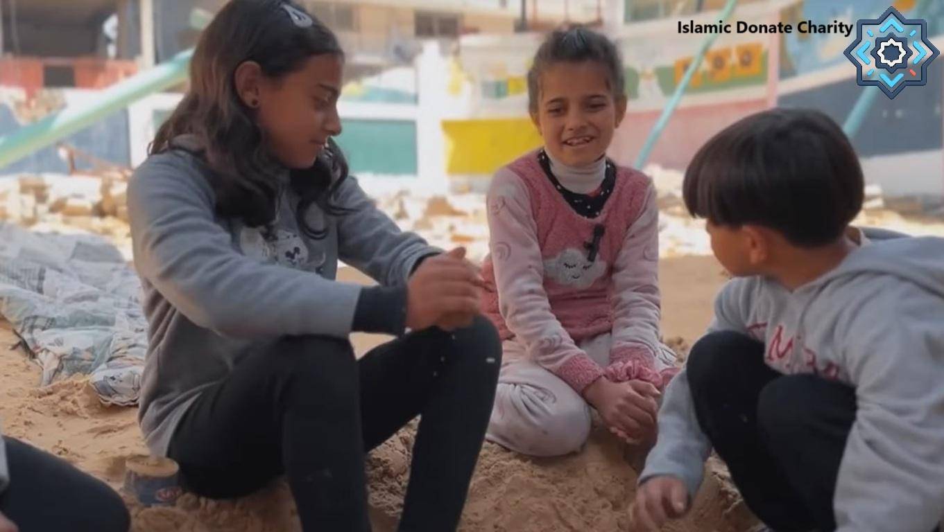 Three children playing in the sand, receiving crypto donations for educational support.