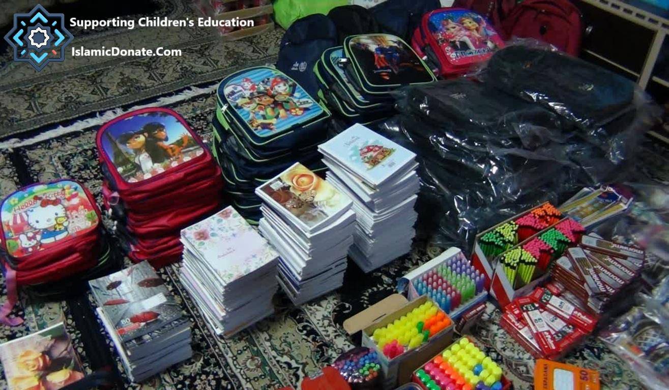 Stacks of backpacks and notebooks, with colored pencils and pens, for children's education, supported by XRP donations for those in need.