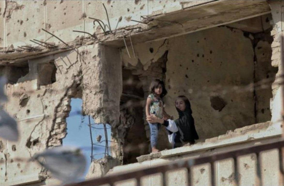 Orphan sponsorship in a war-torn building, showing children in need of food, shelter, and crypto donations for a brighter future. ETH supported aid.
