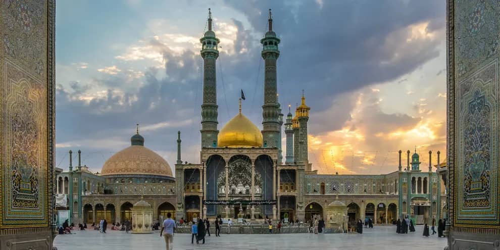 The Holy Shrine of Lady Fatima Masouma (a.s.) adorned with a golden dome and minarets, accepting cryptocurrency donations like Litecoin for faith-driven philanthropy. Donations empower agriculture, outreach, and preservation.