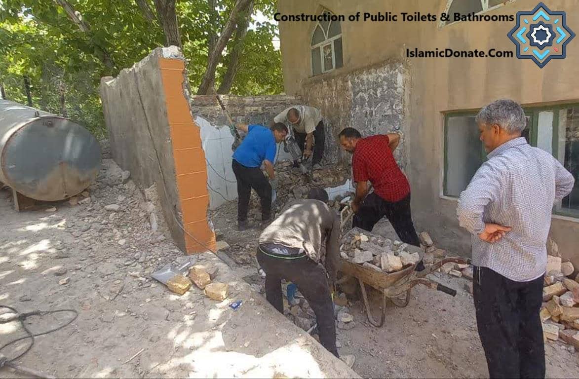 Men demolish a wall for construction and sanitation projects, including field toilets and bathrooms, to improve living conditions for displaced families. Donate crypto like RLUSD to aid urgent needs in Palestine.