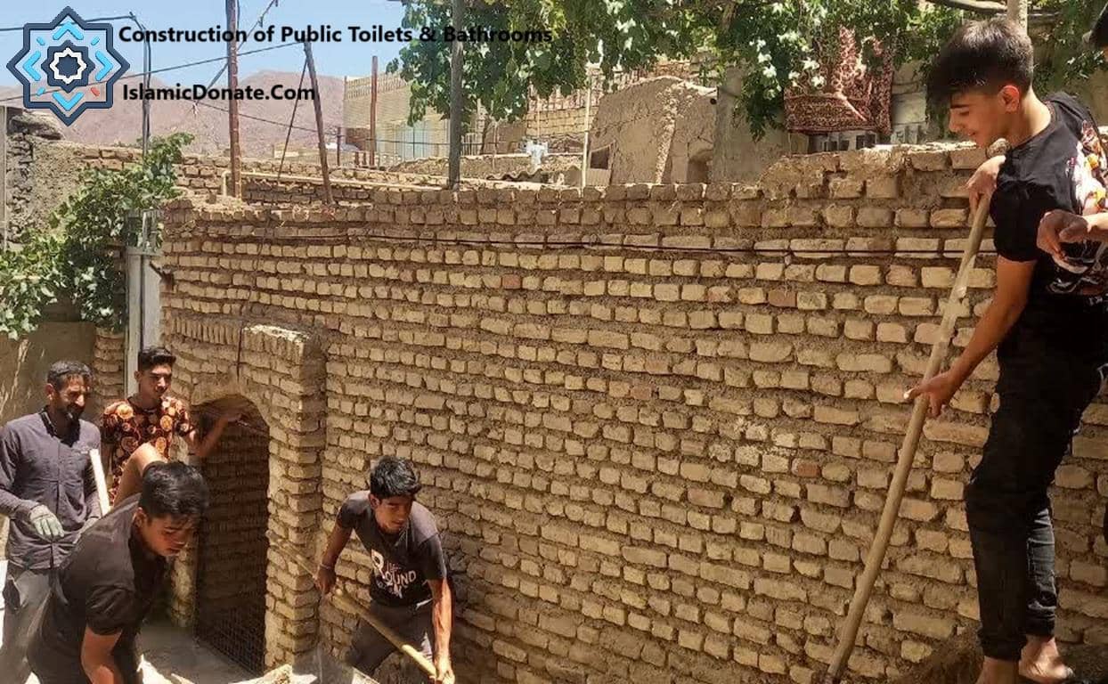 Several men and boys constructing a brick wall, building public toilets and bathrooms in a community requiring aid. Donate crypto like LTC or TRX to support relief efforts.