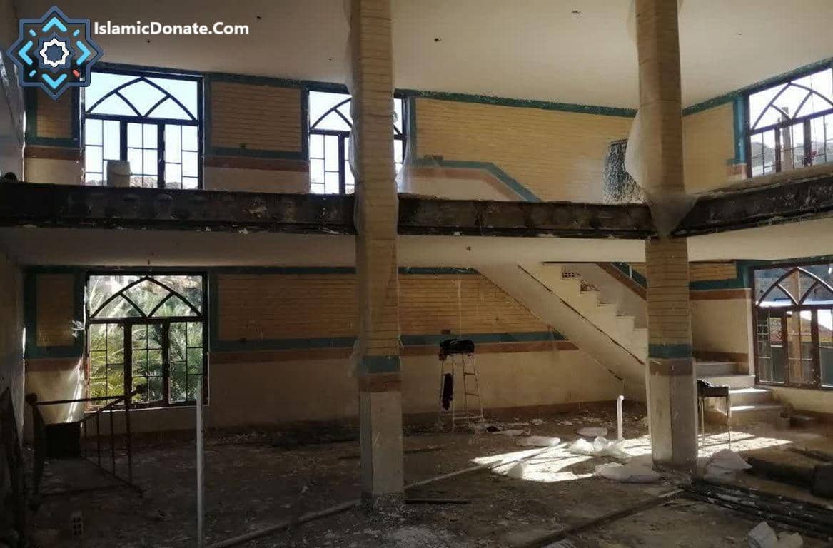 Interior of a building under construction, a mosque with exposed beams, windows, stairs, and debris. Donation to Sadaqah Jariyah projects like building religious infrastructure, education, or water solutions can be made with cryptocurrency such as Dogecoin.
