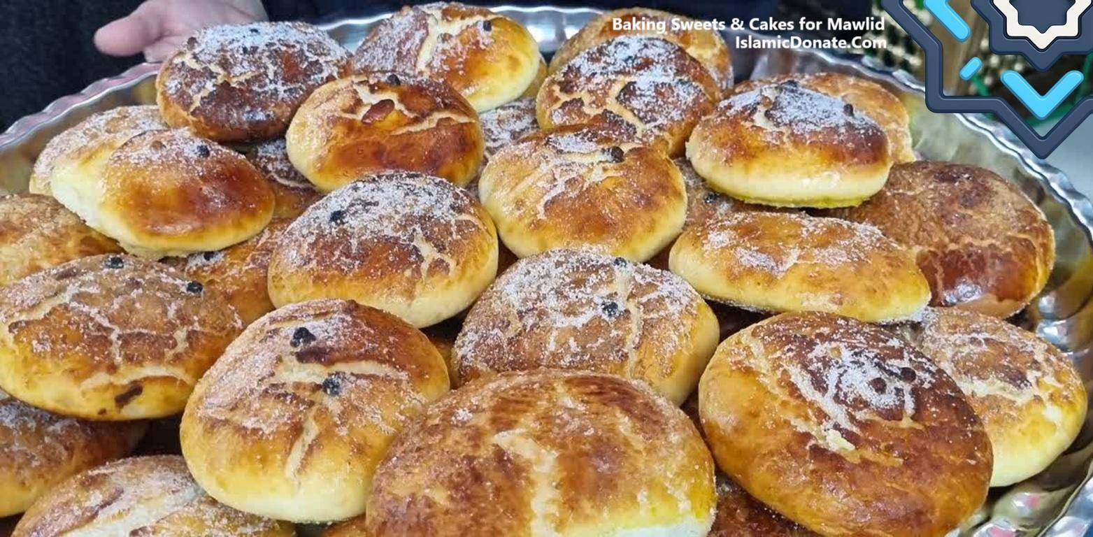 A tray of freshly baked, golden-brown buns dusted with powdered sugar and raisins, symbolizing generosity and community during Mawlid. Crypto donations, such as BTC, help support these baked goods for the needy.