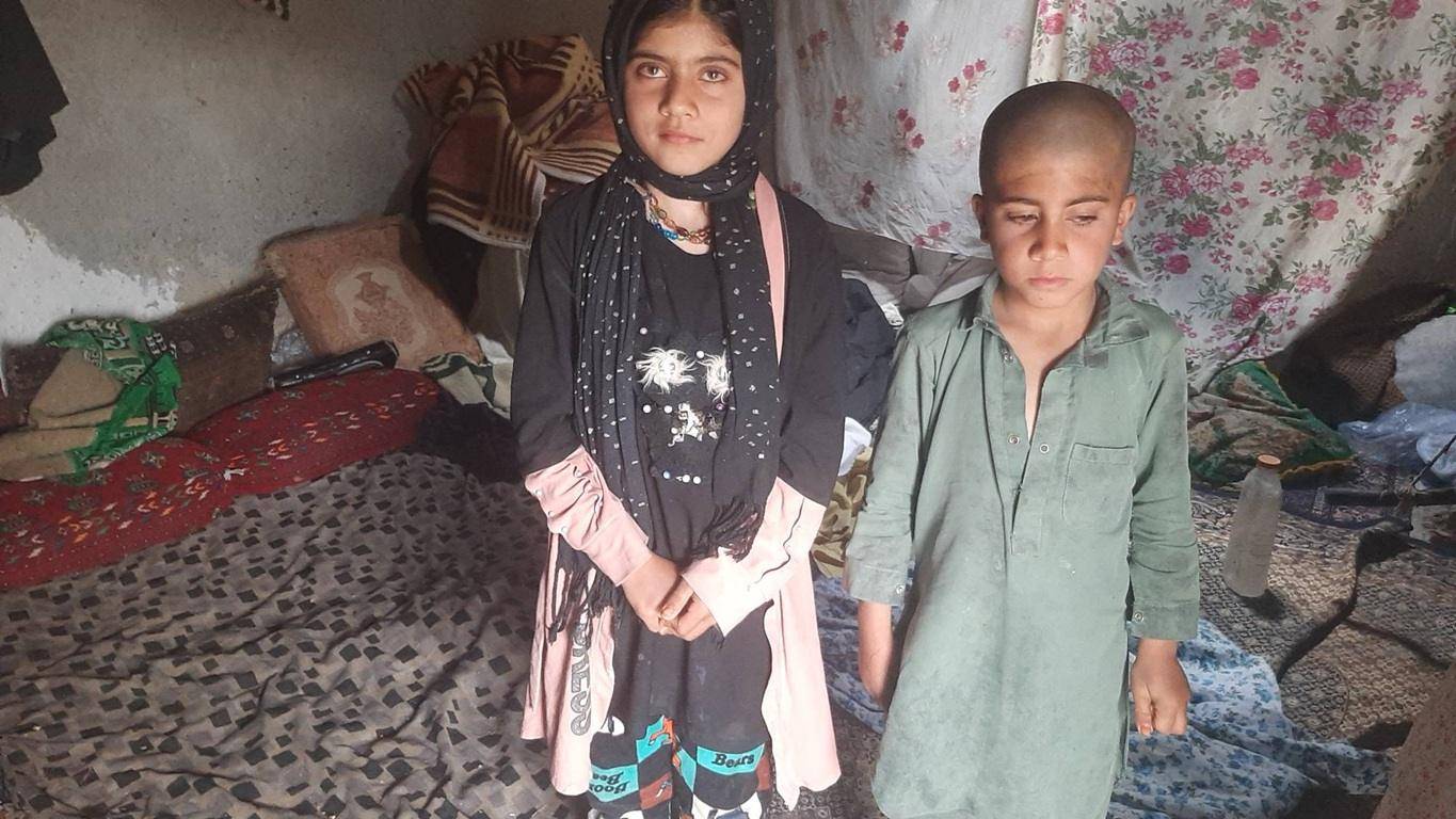 Two children in impoverished living conditions, symbolizing the need for aid through crypto zakat donations.