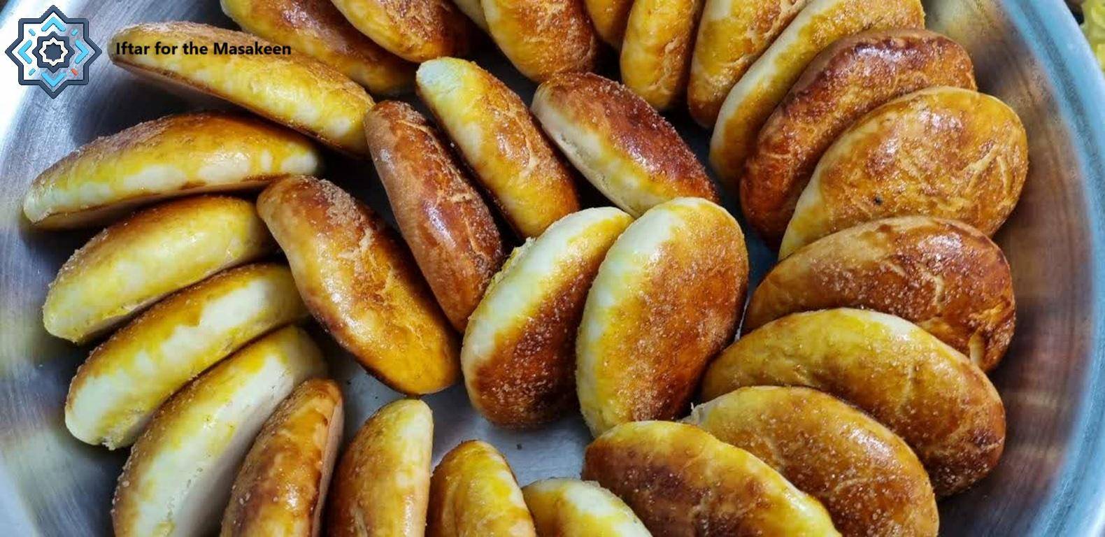 Pile of golden-brown baked goods, offering iftar for the needy, funded by crypto donations like BTC.