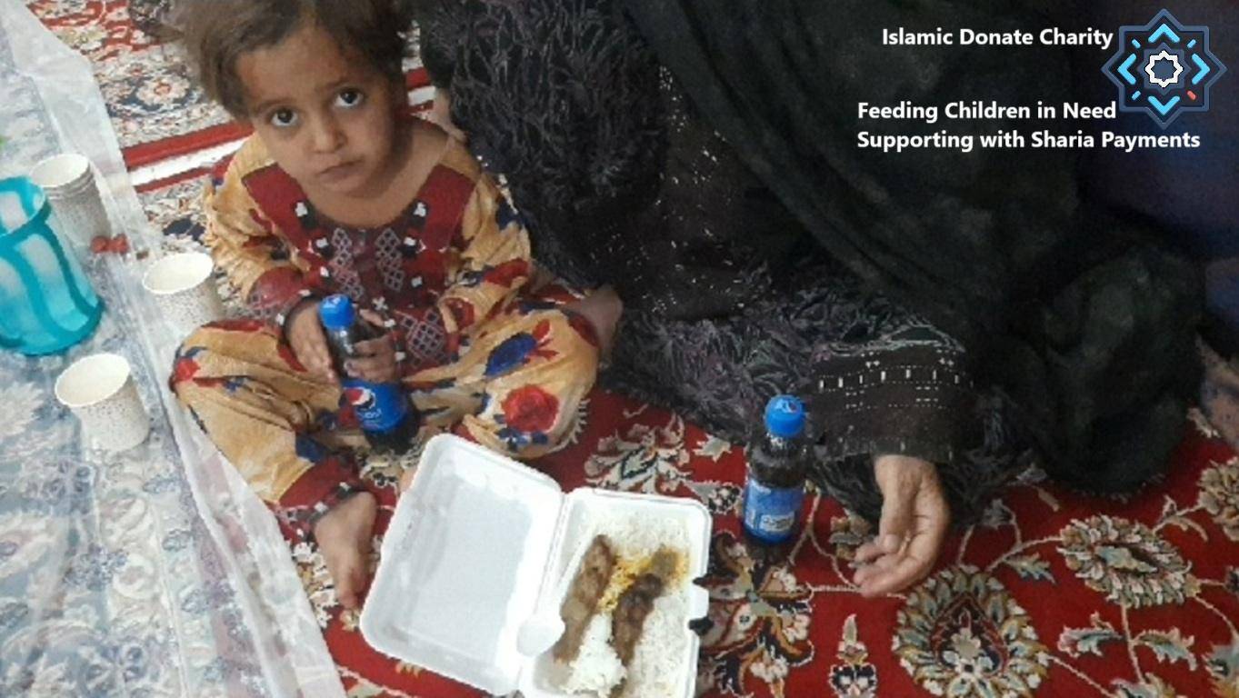 A child sits on a rug holding a beverage, with a meal box and cups nearby. This image highlights feeding children in need with crypto donations, like ETH, for Ramadan.