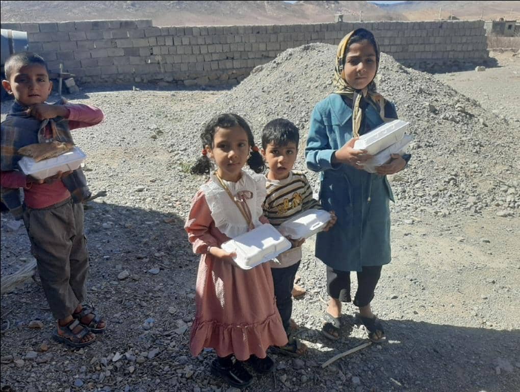 Children holding food containers for iftar, representing crypto zakat donation supported by ETH.