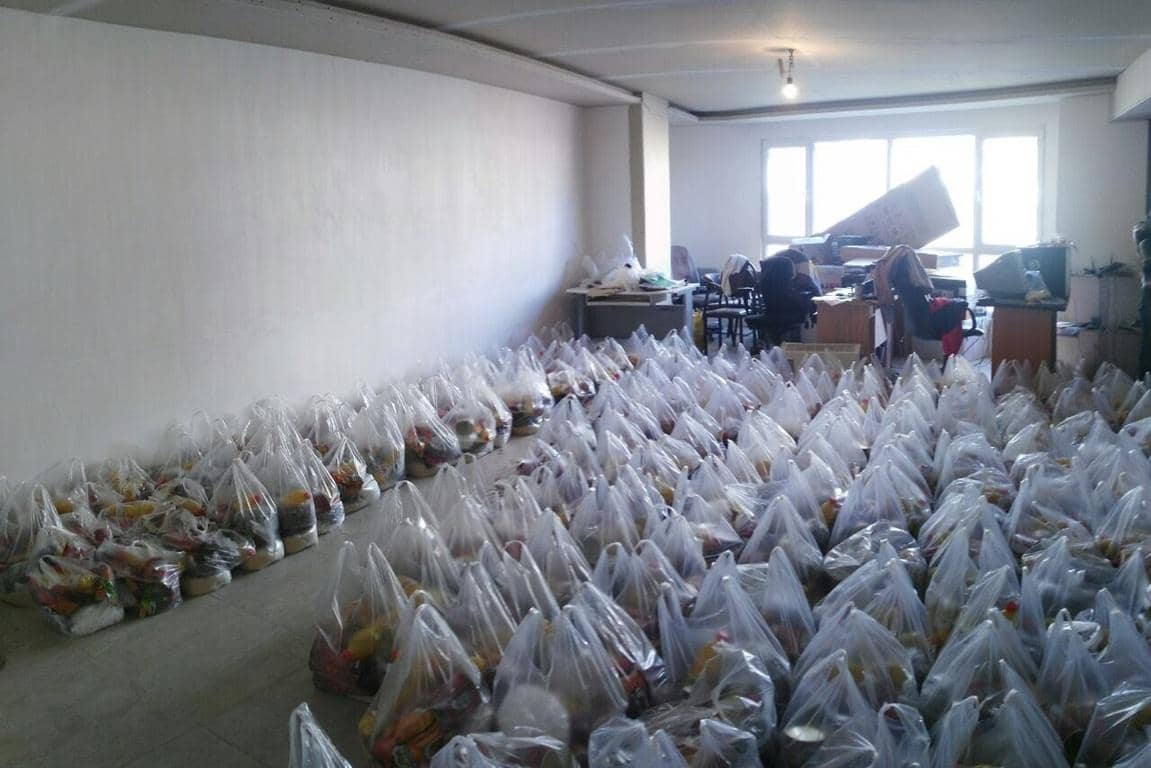 Rows of packed food bags prepared for distribution, featuring various food items, crypto donation support with ETH.