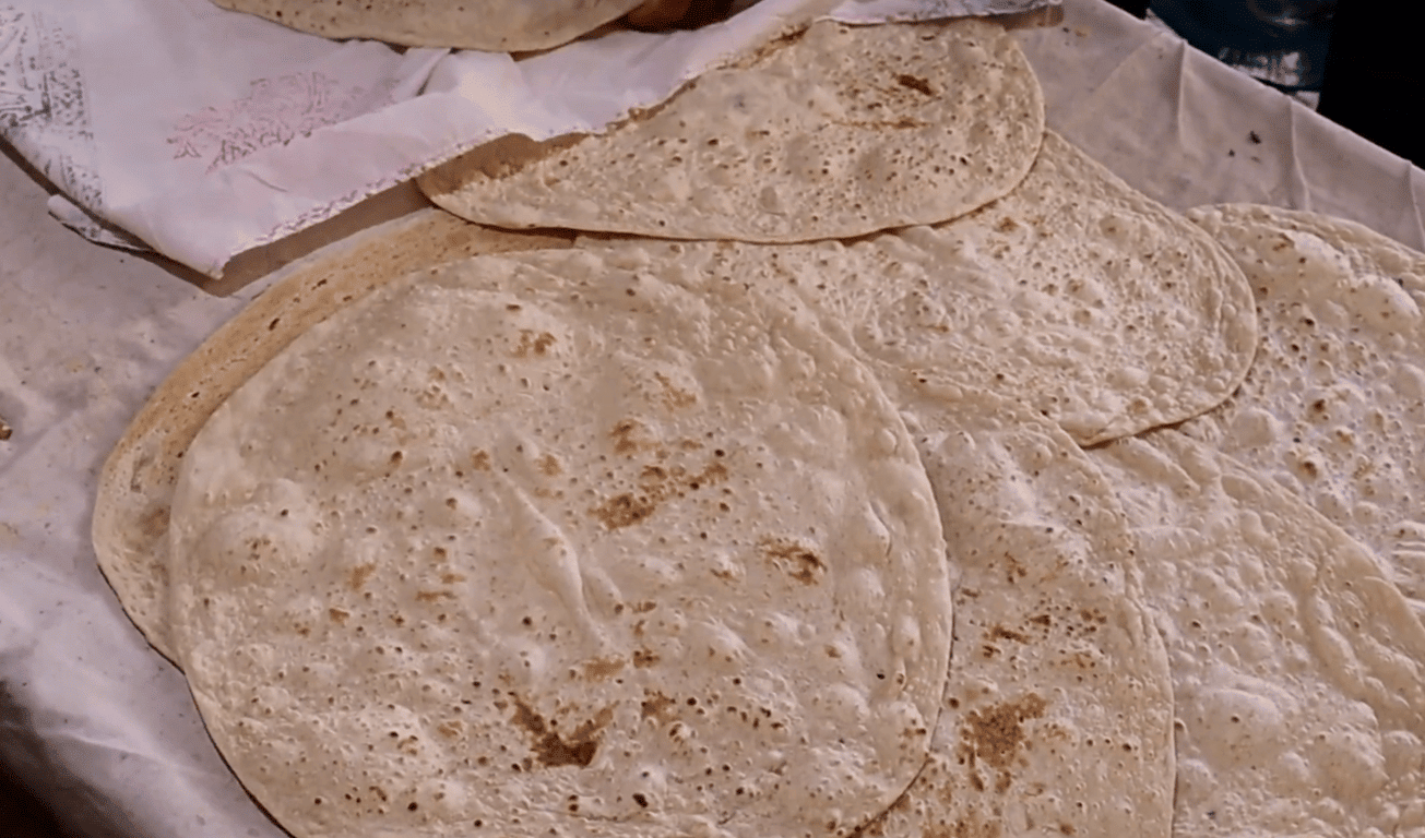 Stack of flatbread, representing food donations made via crypto for anonymous giving, with an emphasis on hidden sponsorship and humanitarian aid.