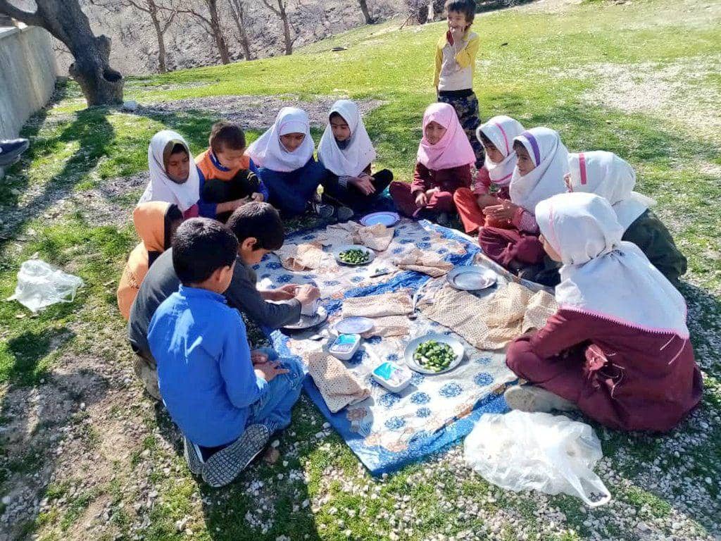 Group of children sharing a meal outdoors, anonymous crypto donations for aid and support. Supported by Litecoin.
