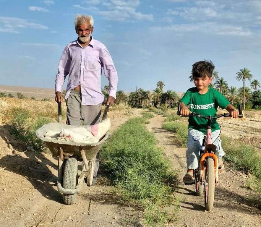 Adnan and his grandfather building a rural waterway