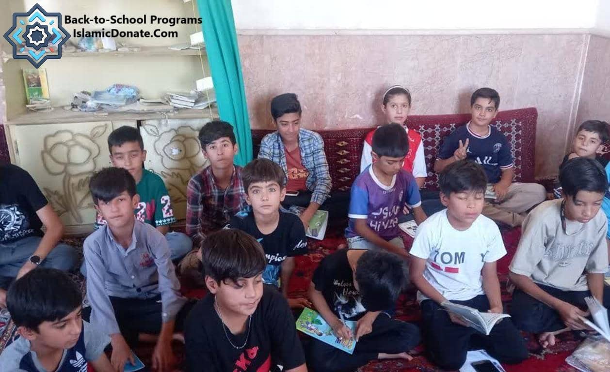 Children sitting and reading books, part of Sadaqah Jariyah education projects for lasting rewards, donations accepted via BTC.