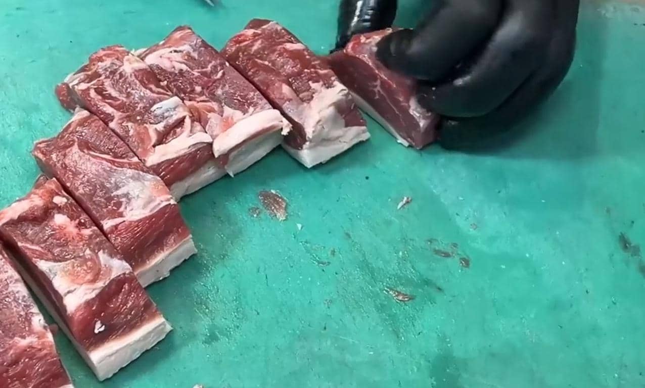 Chopped meat being prepared for Ramadan 2026 in charity kitchens, with focus on 1500 kilos of compassion and crypto donations facilitated by Stablecoin.