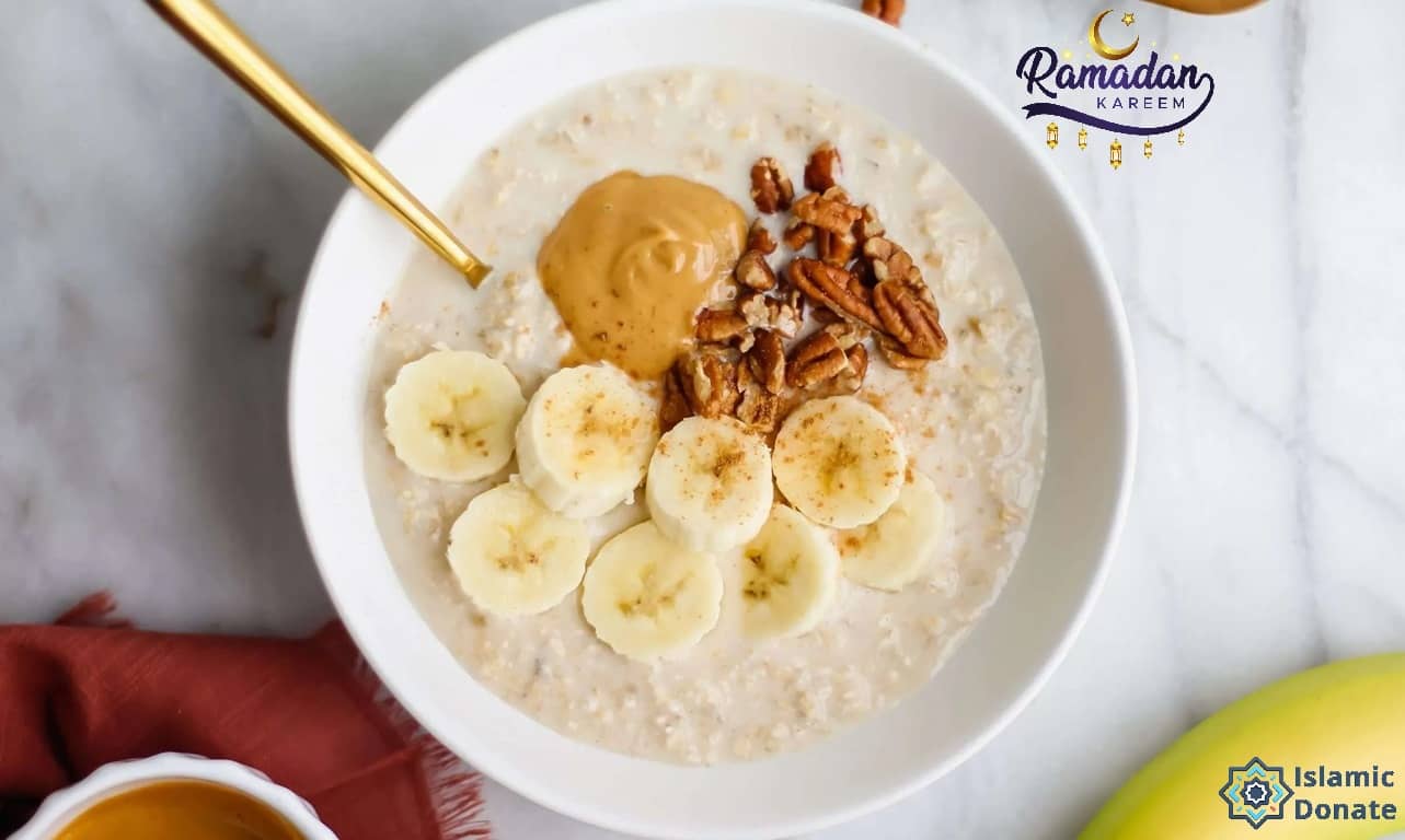 Ramadan oatmeal bowl with banana slices, peanut butter, and nuts, perfect for sustained energy. Supports charitable donations via crypto like USDT.