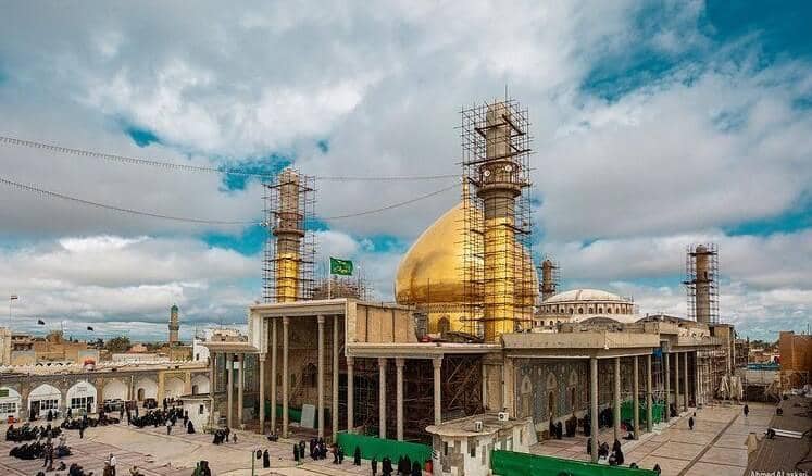 The Imam Hasan al-Askari Holy Shrine in Samarra, Iraq, with its golden dome topped with scaffolding, accepting Bitcoin donations for global charitable giving.