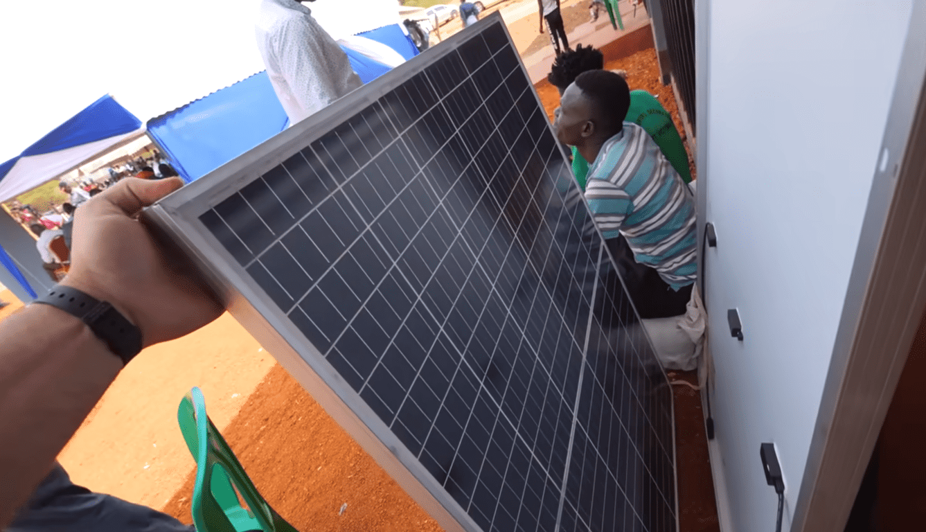 Hands hold solar panel to power small businesses, supported by crypto donations like Ethereum, empowering families with renewable energy and sustainable income.