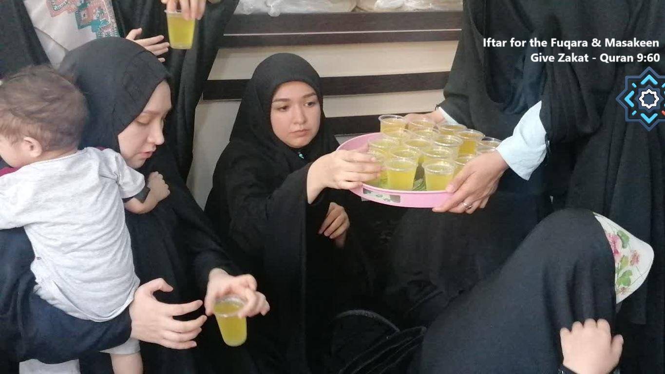 Iftar for Fuqara and Masakeen, involving crypto ETH donations. Women and a child are receiving drinks from a tray, highlighting aid distribution supporting the Muslim community.