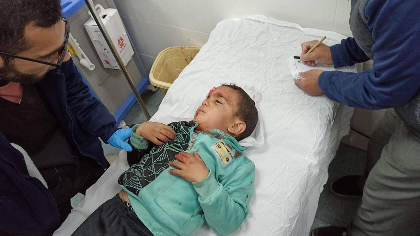 Injured child receiving medical attention in a clinic, donation via XRP supports urgent treatment for vulnerable populations.