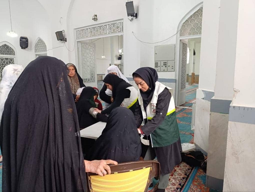 Medical staff assisting women with blood pressure checks, supporting general healthcare and women's health programs funded by ETH donations.
