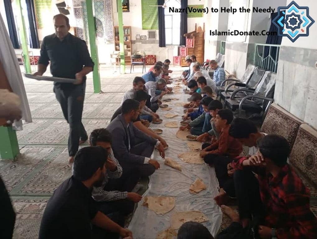 A man carries a tray of food to a group of people sitting on the floor for a meal, symbolizing Nazr vows and cryptocurrency donations for the needy.