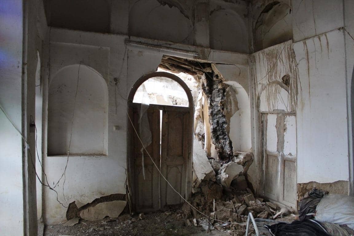 Damaged room with rubble and a doorway, implying urgent need for crypto zakat reconstruction aid via SOL.