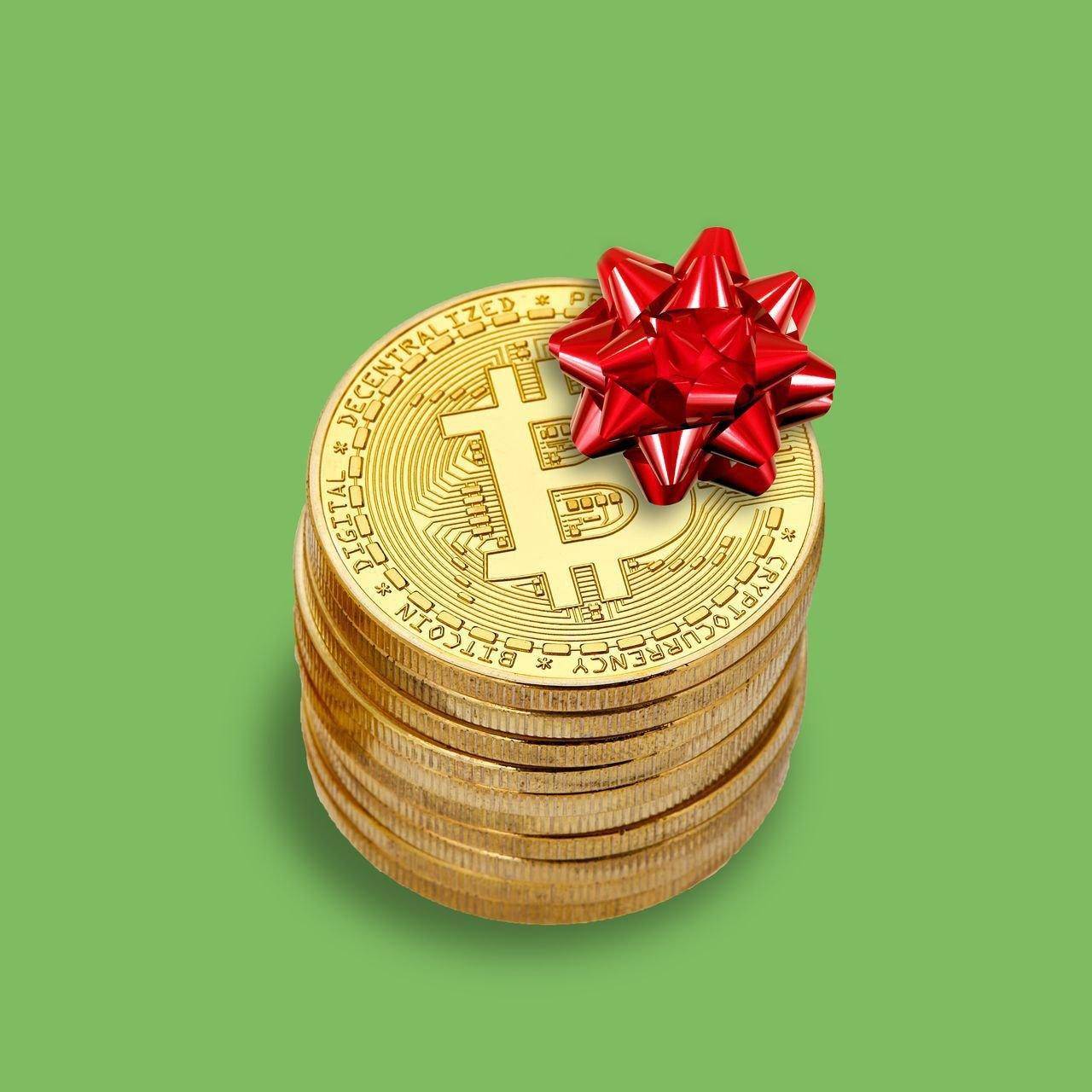 Stack of bitcoin coins with a red bow, representing crypto donations for Islamic relief efforts. Donations processed via BTC.