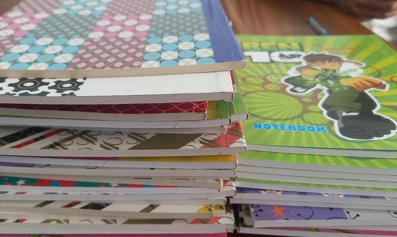 Stack of colorful notebooks, including a Ben 10 themed one, ideal for crypto donations supporting education and relief efforts in Afghanistan. Donate with ETH.