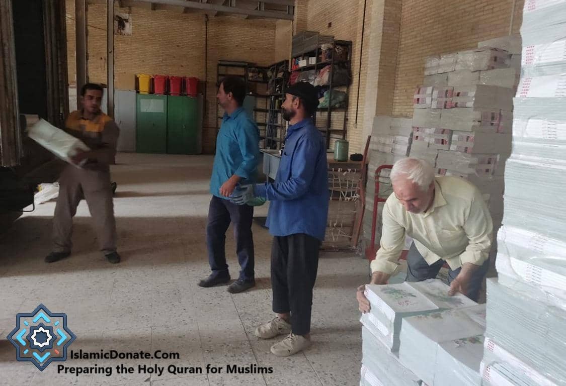 Warehouse workers preparing stacks of Holy Qurans for distribution, with large quantities of books wrapped and ready. Crypto donations like Bitcoin fund this vital humanitarian effort of distributing the Quran in English, Spanish, and other languages, bringing guidance and blessings globally.