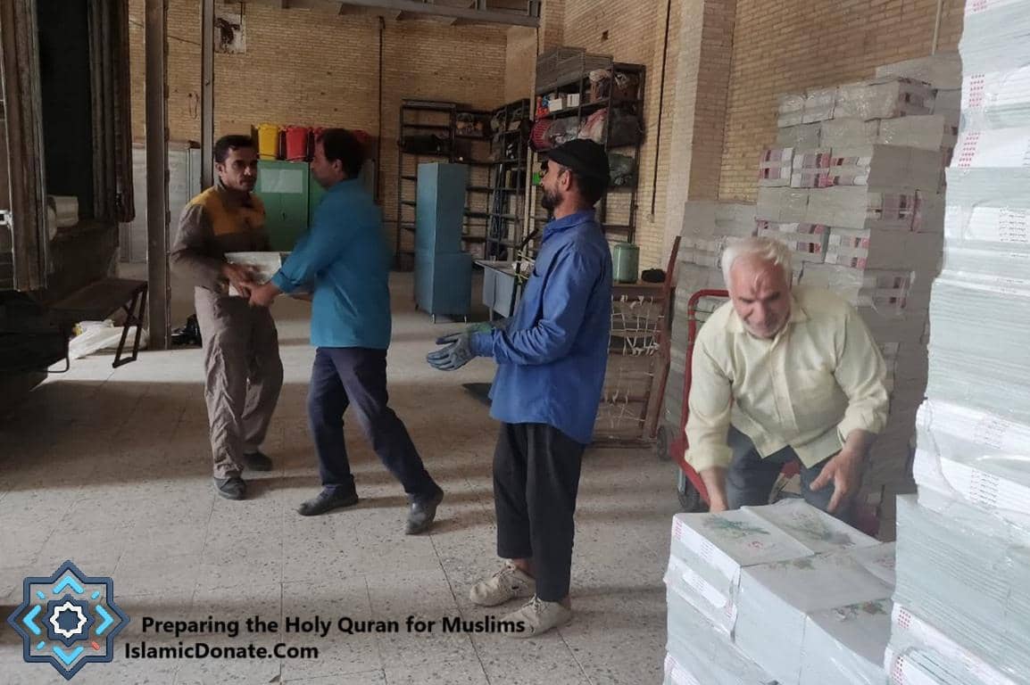 Men preparing and stacking Holy Qurans for distribution, with donations facilitated by BNB cryptocurrency.