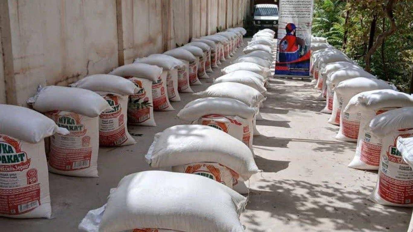 Bags of food supplies staged for distribution in Afghanistan, with crypto donation support via Ethereum.