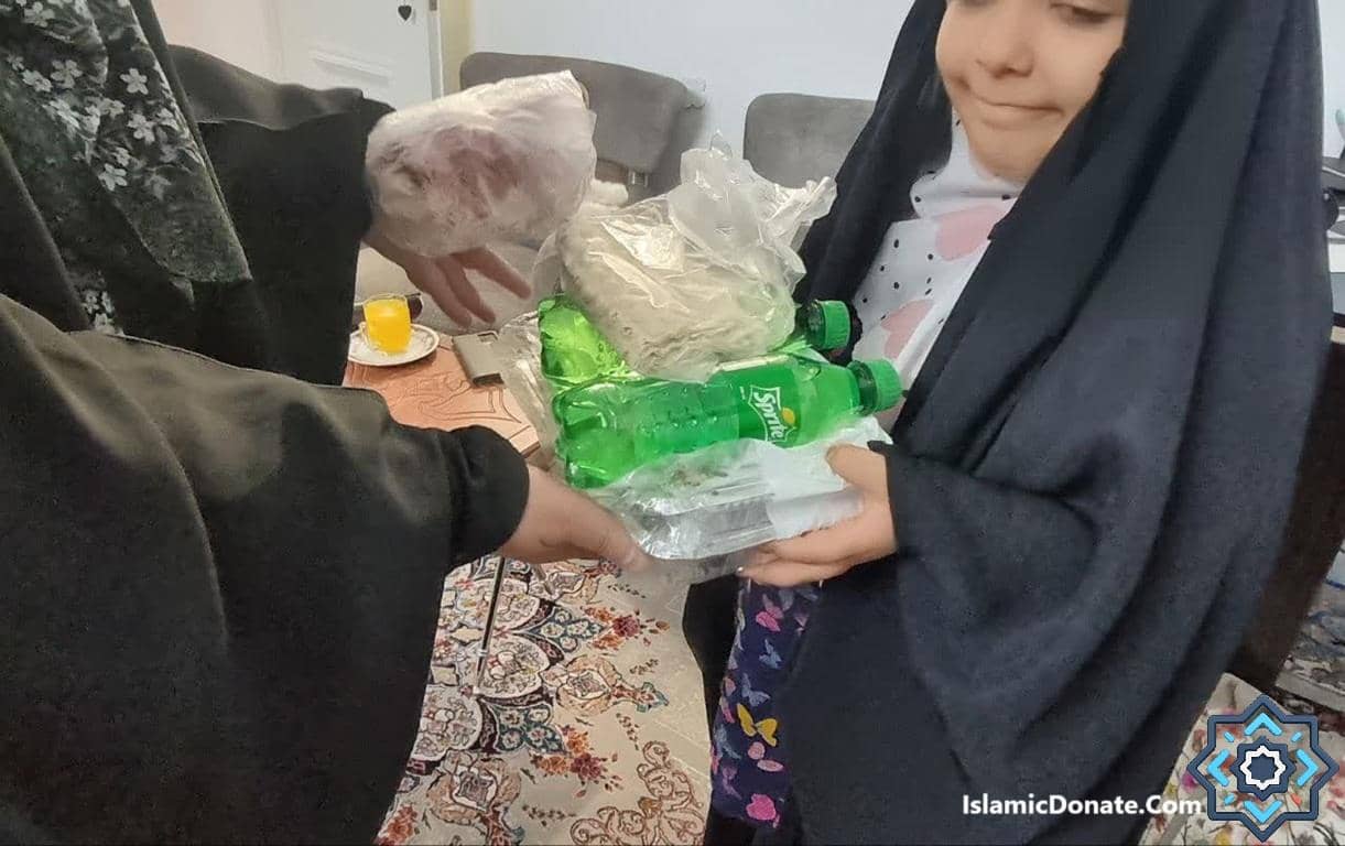 A person hands a young girl a bag of groceries and drinks. This donation is facilitated by Ripple, supporting Zakat al-Fitr donations.