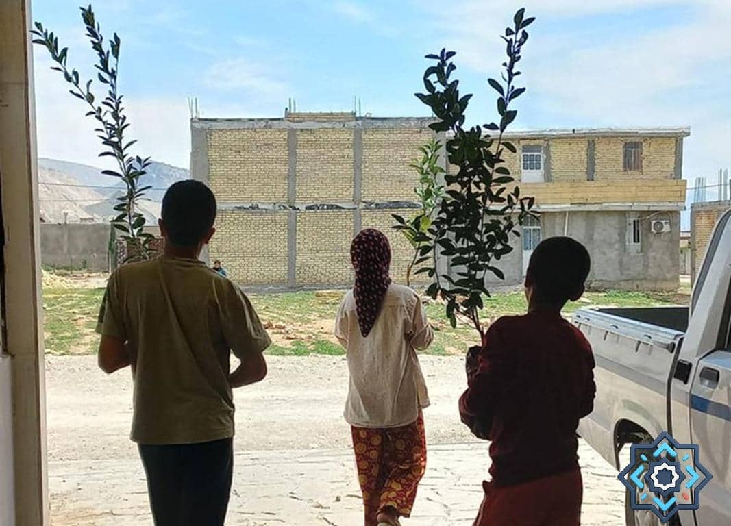 Children carrying young olive trees in a village setting, symbolizing hope and sustainable livelihoods through crypto donations like ETH. This project supports families in breaking the cycle of poverty.