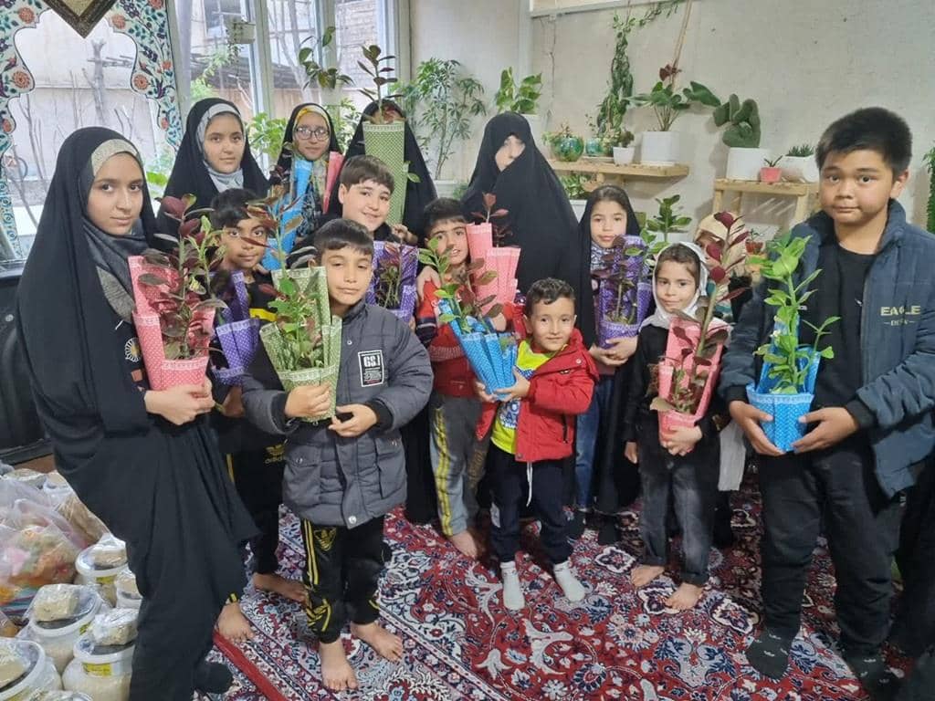 Children and adults holding potted plants, symbolizing Zakat al-Fitr donation, supported by SOL cryptocurrency for Ramadan charitable giving.