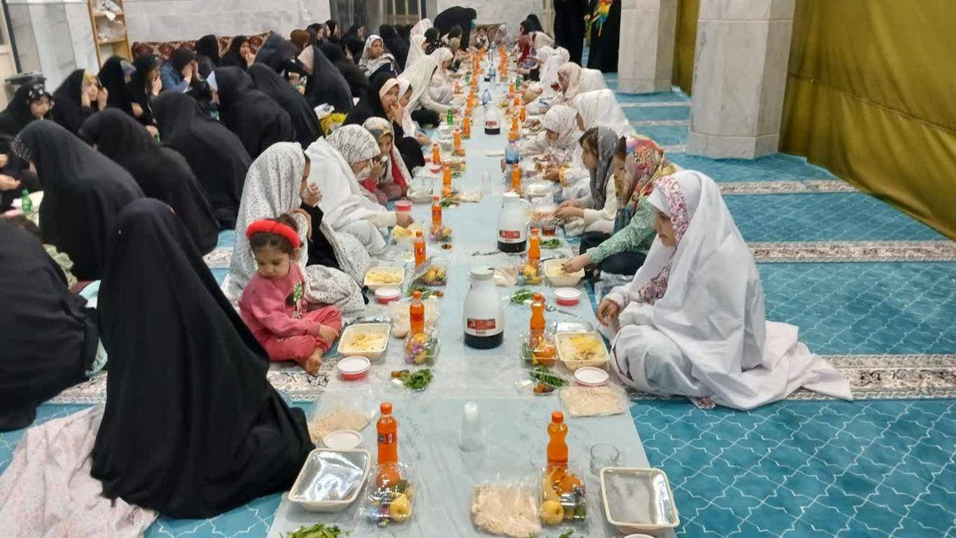 Group of Muslim women and children gathered for Iftar, sharing a communal meal with food laid out on mats. This scene represents the spirit of Zakat al-Fitr and community bonding, with donations facilitated by cryptocurrency like Bitcoin.