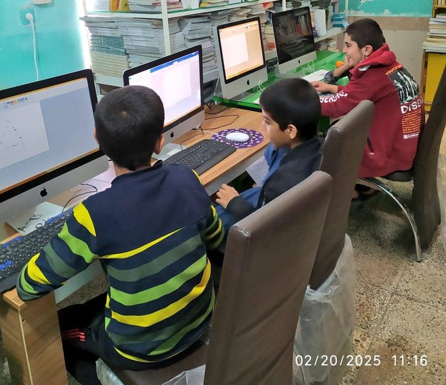 Boys using computers in a classroom, made possible by crypto donations for children's education. Funded by BTC, your support helps rebuild futures.