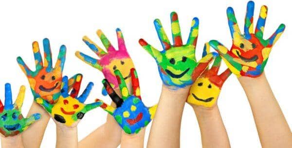 Children's hands painted with colorful smiley faces, symbolizing hope and joy in orphan sponsorship, with crypto donations supporting global aid through RLUSD.